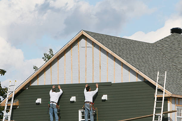 Professional Storm Damage Siding Repair technician working in Lawrenceburg, KY